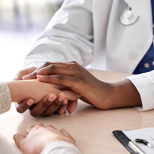 Doctor's hands holding patients for comfort